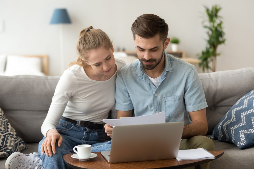 Young couple researching builders