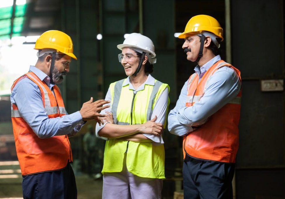 Group engineers wearing helmet and vest